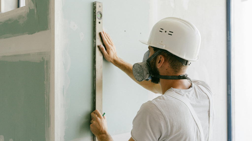 Measuring drywall before cutting